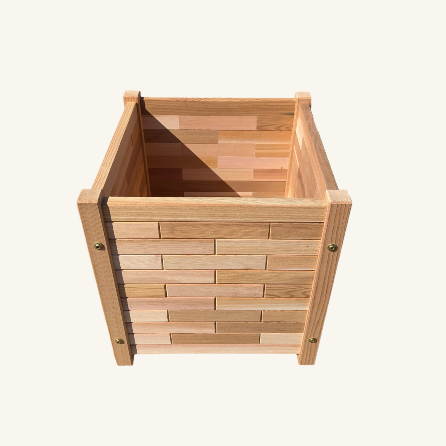 Close-up of 17-inch tall square cedar garden box showing brick themed paneling and smooth cedar finish, handmade in BC by Kelowna Woodcraft.