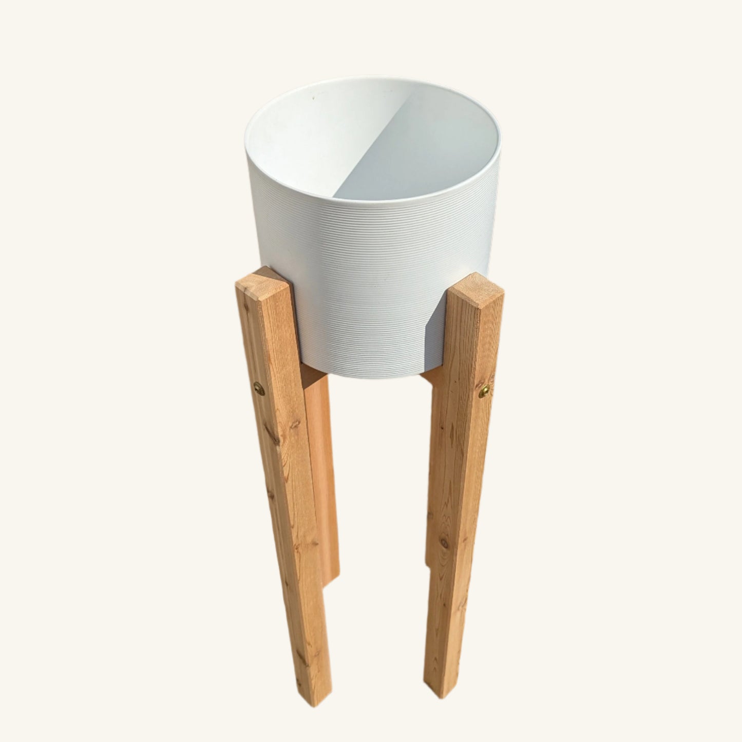 Top-down view of ceramic planter seated in tall cedar stand, showing planter depth and precision wood craftsmanship.