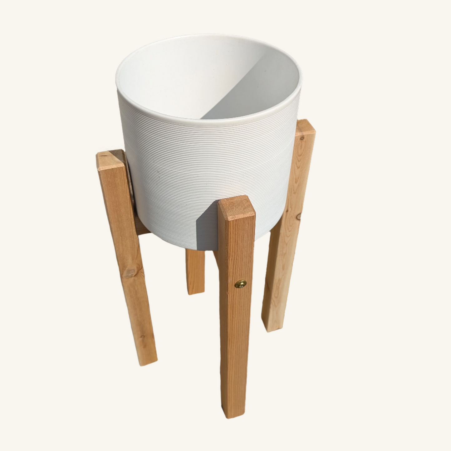 Top-down view of ceramic pot seated in short cedar plant stand, revealing deep pot capacity and square leg symmetry.