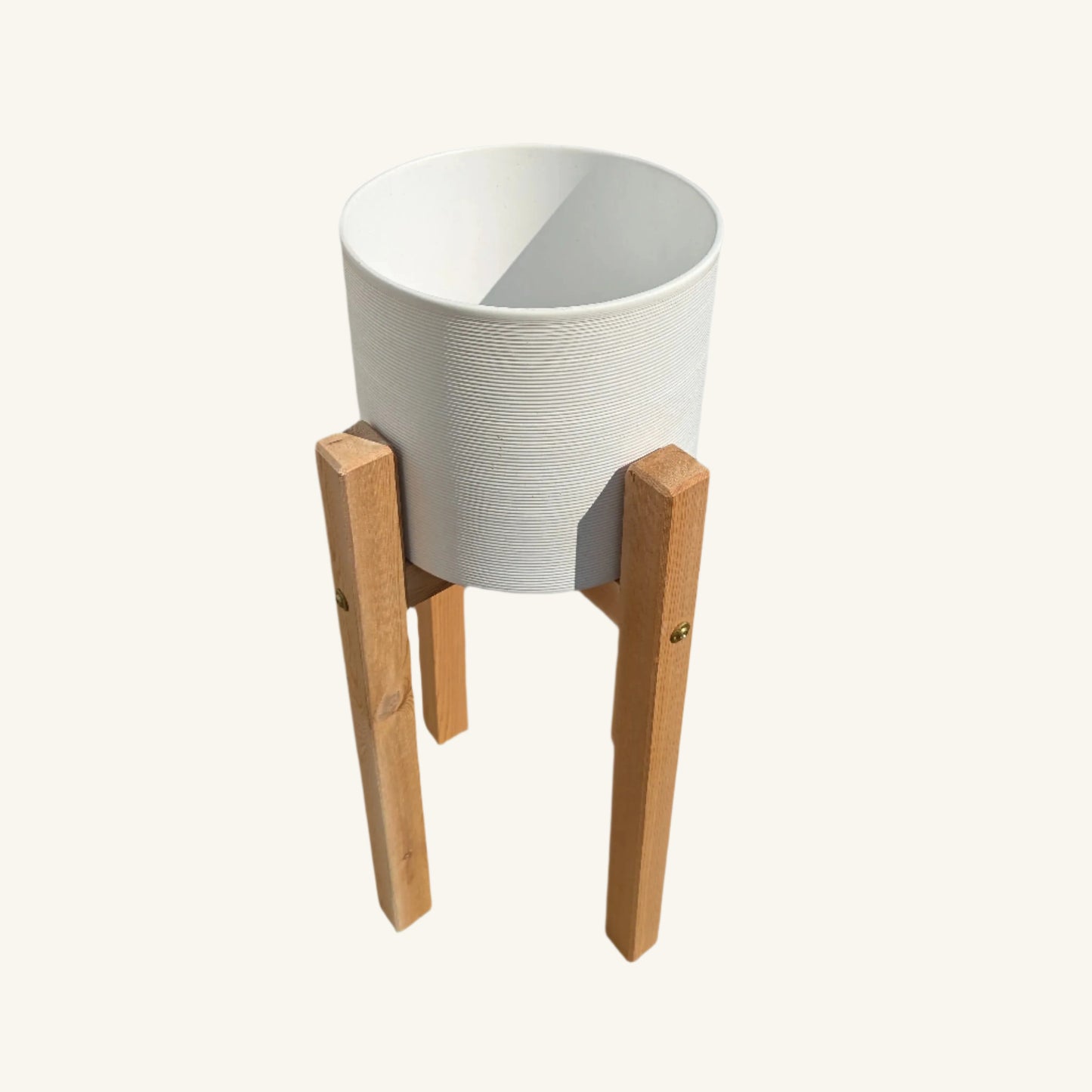 Angled view of small cedar and ceramic planter stand, combining rustic cedar warmth with a modern ceramic silhouette.