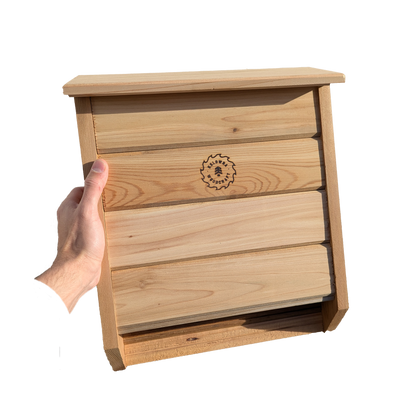 Cedar bat box mounted on a tree in a natural outdoor setting, providing safe shelter for bats while enhancing backyard ecosystems, handcrafted in BC by Kelowna Woodcraft.